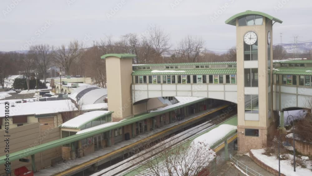 Ramsey, NJ - USA - Feb 14, 2021: New Jersey Commuter train pulling into Ramsey Route 17 train station on a winter day. Ramsey, NJ - USA - Feb 14, 2021: New Jersey Commuter train pulling into Ramsey Route 17 train station on a winter day.