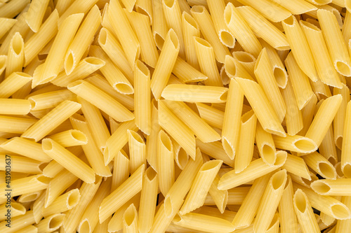 Lot of penne macaroni background texture