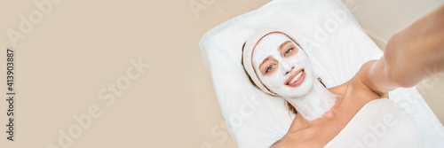 Portrait of moisturizing mask on white background for medical design. Woman skin procedure. Natural cosmetic products. Beauty face. Facial cosmetology treatment. Healthcare. Selfie at spa center