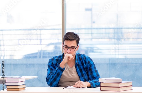 Student studying in the empty library with book preparing for ex photo