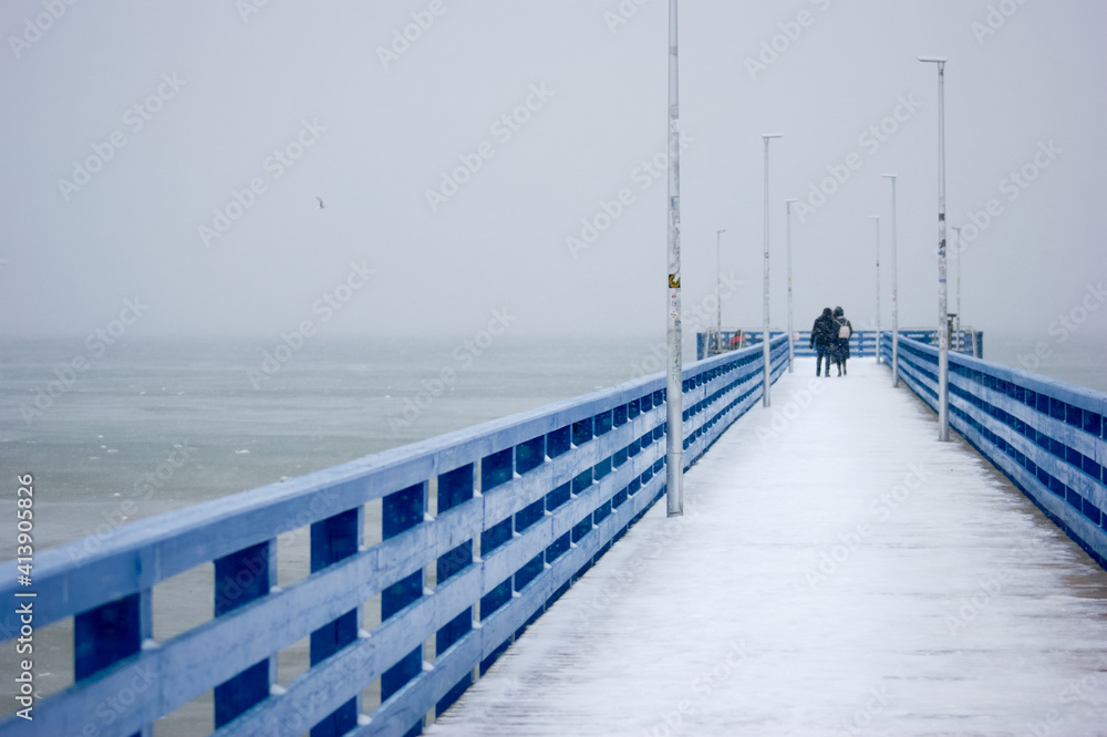 person on the pier winter baltic sea