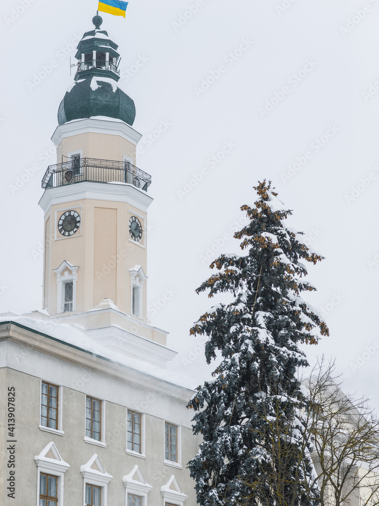 DROHOBYCH, UKRAINE - FEBRUARY 10, 2021: The fir-tree on the background of the Drohobych City Hall.