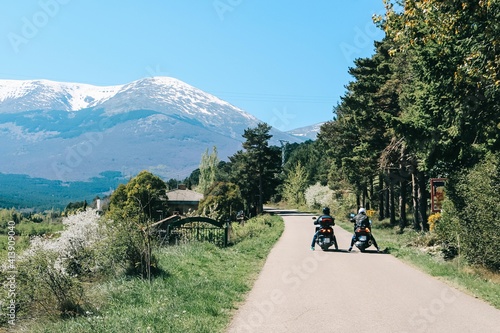 Mountain landscape with two motorbike riders photo