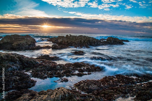 Sunset  and waves on rocks at Asilomar State Beach, Monterrey California photo