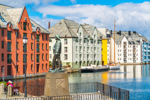 Fiskergutten or fisher boy statue, Brosundet Canal, Alesund, Norway photo