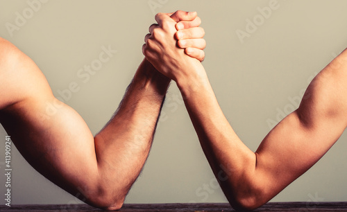 Bilde på lerret Arm wrestling thin hand and a big strong arm in studio
