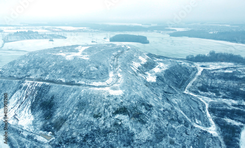 Top view from drone on blue snowy mountain in winter
