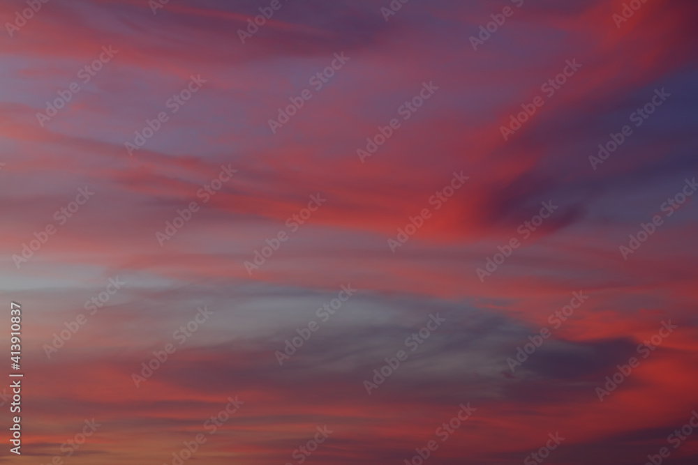 Dramatic red and orange sky and clouds abstract background. Red-orange clouds on sunset sky. Warm weather background.
