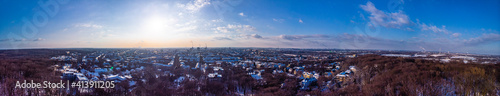 View of the snow-covered skyline of Duisburg at sunset from above