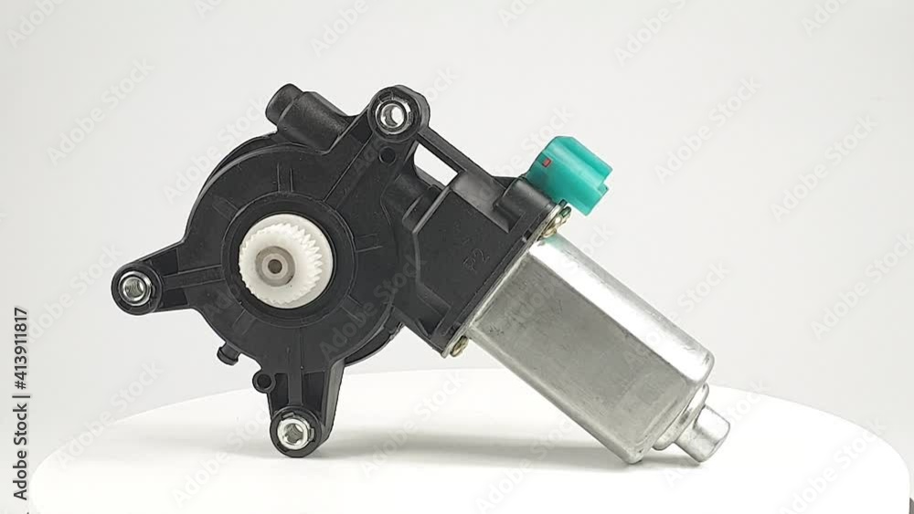 car spare part, electric motor for car window lifters rotates on white background car spare part, electric motor for car window lifters rotates on white background
