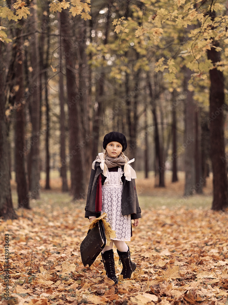 A beautiful girl with pigtails goes home from school. She is wearing a school uniform. The shooting is stylized in the style of Soviet Russia. A beautiful girl with pigtails goes home from school. She is wearing a school uniform. The shooting is stylized in the style of Soviet Russia.