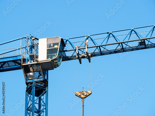 Close up details with a cabin control of a construction crane.Turret Slewing Crane against blue sky