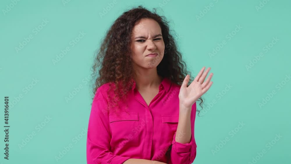 Puzzled pensive young african american woman 20s years old in pink shirt posing isolated on blue turquoise background studio. People lifestyle concept. Looking aside up put hand prop up on chin say no Puzzled pensive young african american woman 20s years old in pink shirt posing isolated on blue turquoise background studio. People lifestyle concept. Looking aside up put hand prop up on chin say no