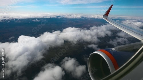 Majectic high angle view of beautiful cloudscape. Scenic aerial view of cloudy landscape and turbina from airplane window. Concept of aviation, flying transport and travel photo