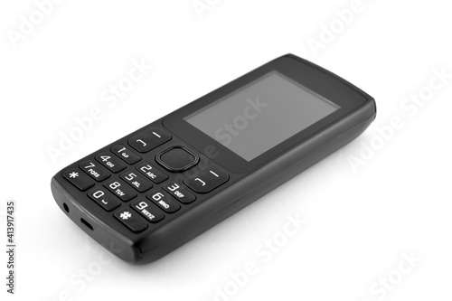 Classic push-button mobile phone. Black telephone on a white background, isolated.