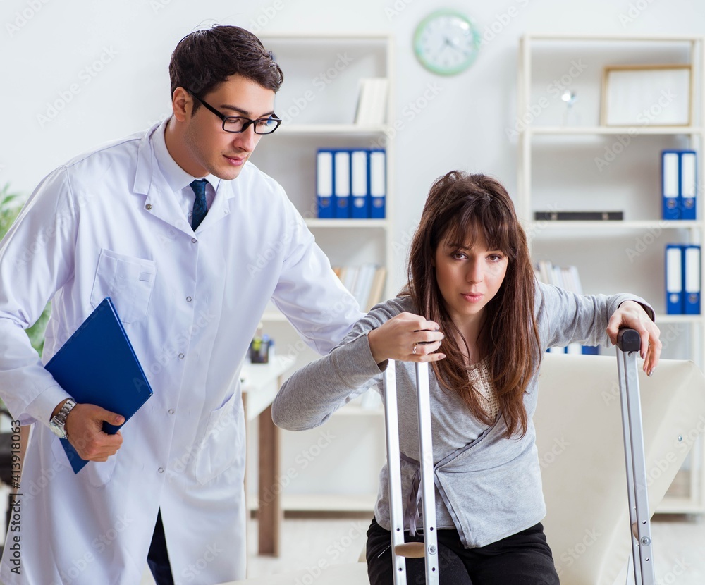 Doctor examining patient with broken leg Doctor examining patient with broken leg