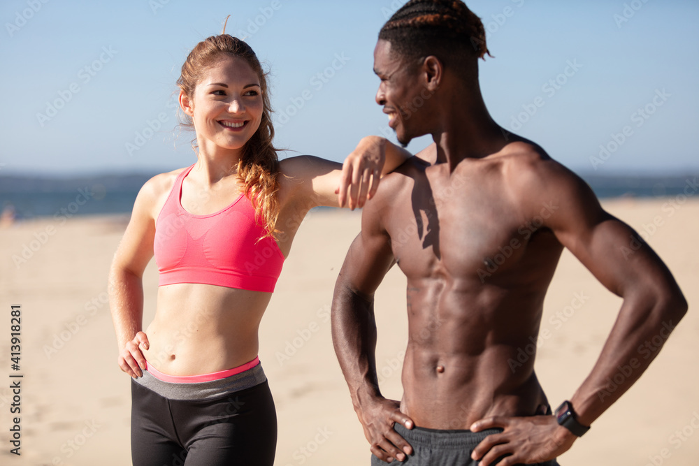 fit mixed-race couple on the beach fit mixed-race couple on the beach