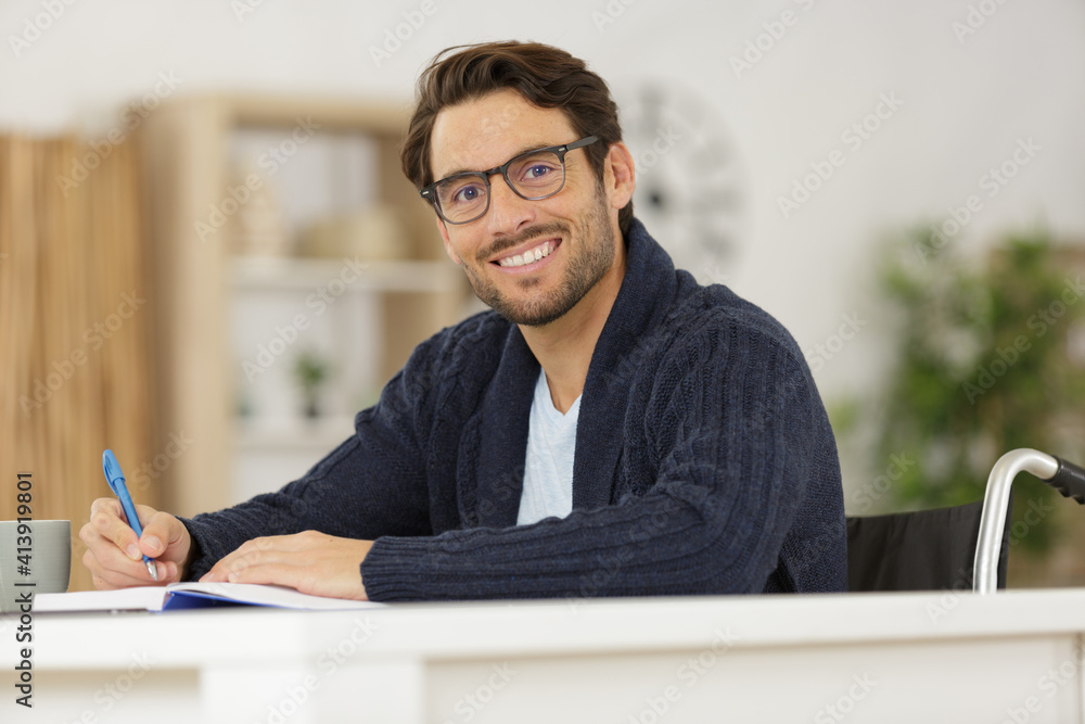 disabled young man studying at home disabled young man studying at home