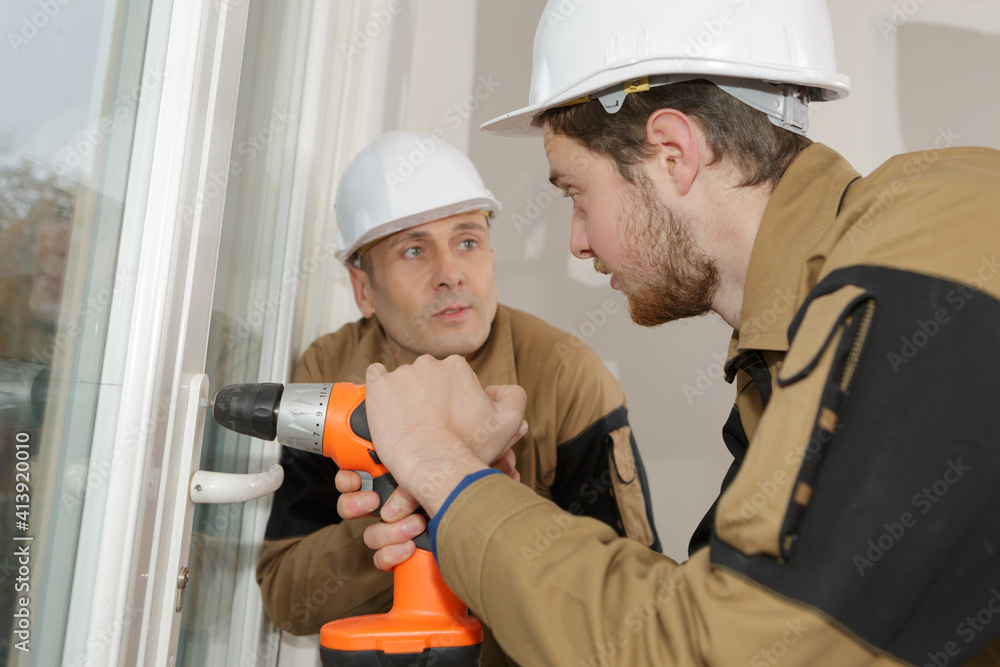 construction workers installing window in house construction workers installing window in house