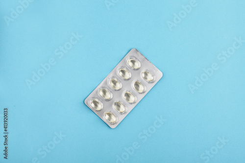 Blister pack of medicine pills on a blue background.