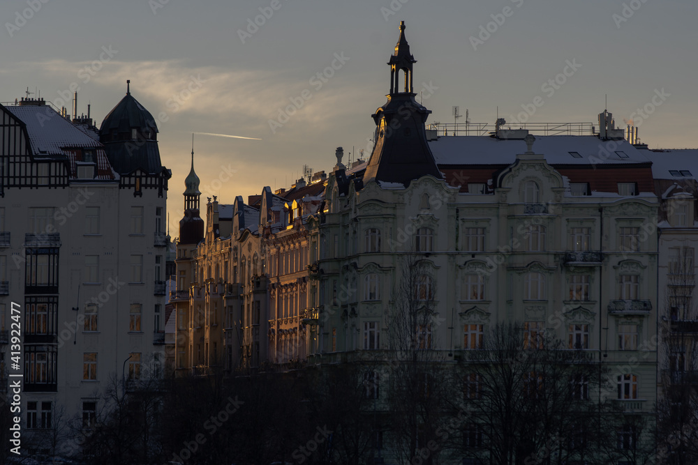 .silhouettes of prague architecture and light from the setting sun in winter in the center of prague