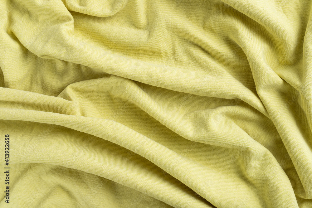 Crumpled linen cloth texture. Wrinkled textile. Yellow