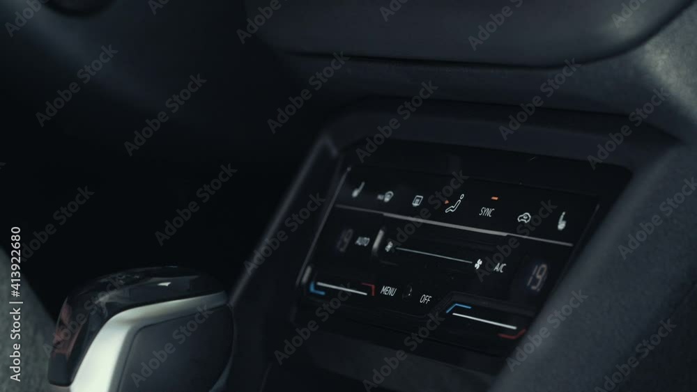 New modern sensor car climate control panel or console of air conditioner, male finger touches sensor buttons, close up. New modern sensor car climate control panel or console of air conditioner, male finger touches sensor buttons, close up.
