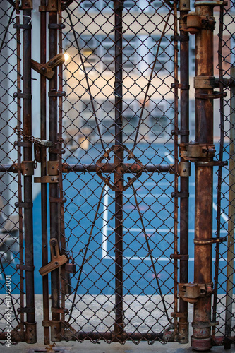 Rusted Gate Fence door to basketball court
