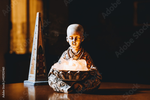 Illuminated monk and crystals and incense for meditation photo