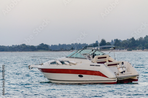 Pefkochori, Greece - May 30, 2016: Anchor red and white boat at the beach in Pefkochori, Greece 