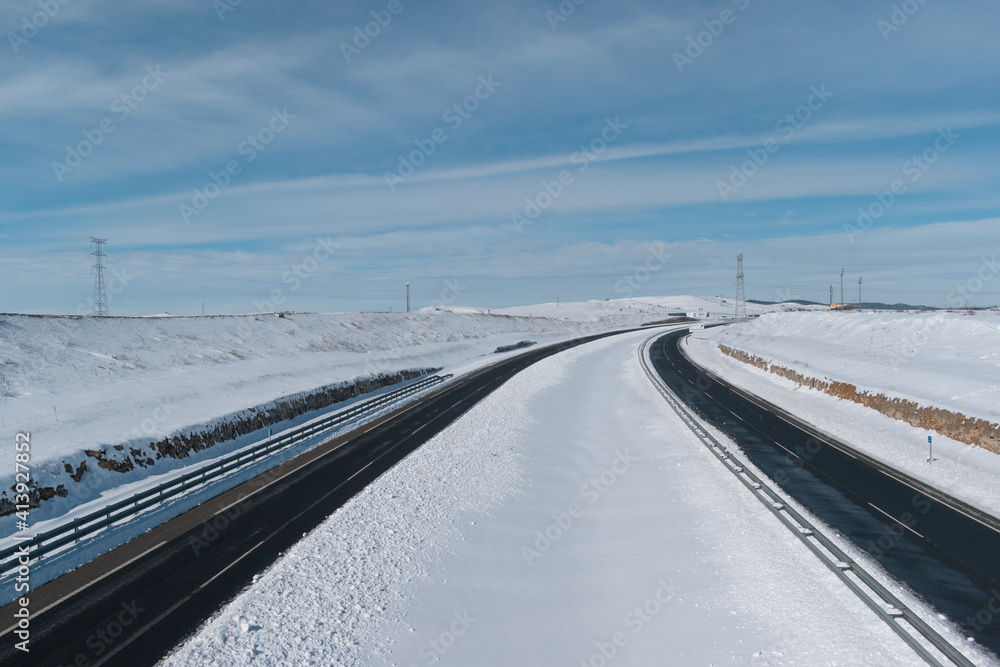 snowy highway recently cleared by snowplows snowy highway recently cleared by snowplows