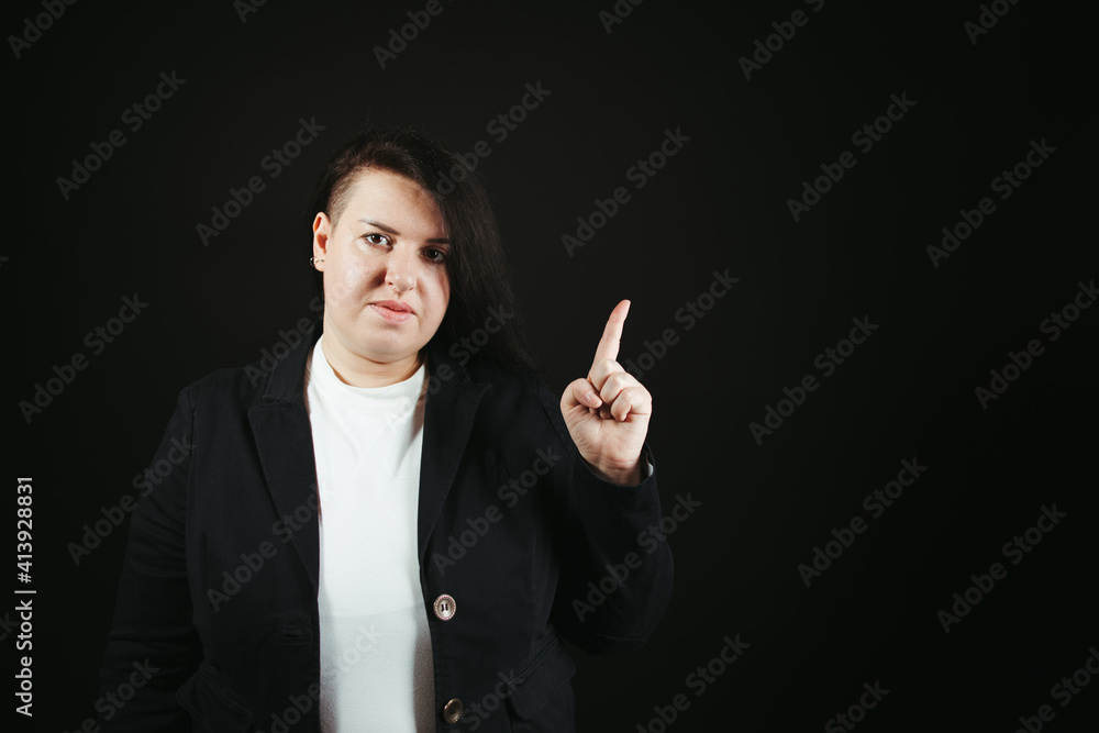 Woman pointing on black background, free space Woman pointing on black background, free space