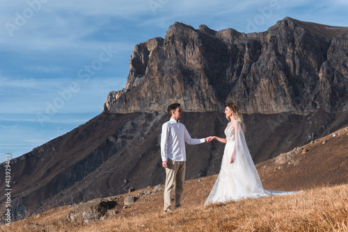 A newlywed couple on the background of beautiful autumn mountains. The concept of holding a wedding in nature, love, family and relationships