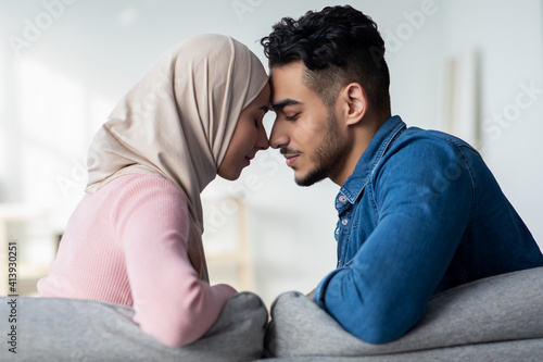 Closeup of loving muslim couple bonding at home