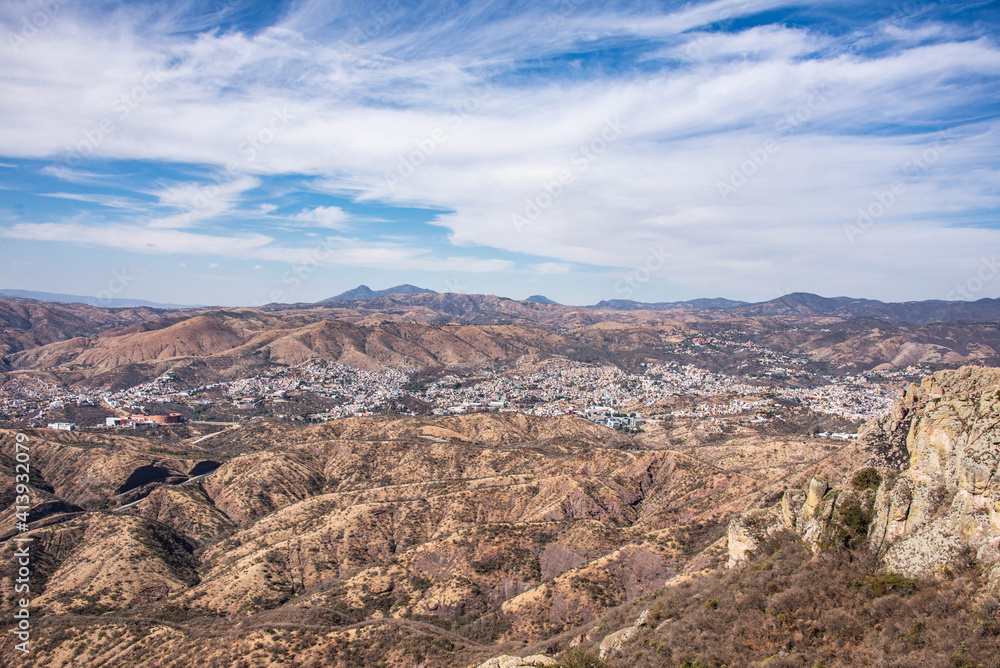 Panoramic Aerial view of Guanajuato, Mexico surrounded by mountains.