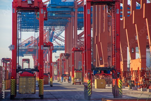 Cranes and containers in the container harbour port during logistic loading process at day time