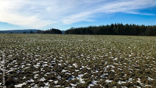 field with snow and sky on a sunny day