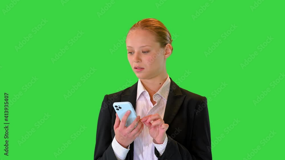 Serious attractive businesswoman using her phone on a Green Screen, Chroma Key. Serious attractive businesswoman using her phone on a Green Screen, Chroma Key.