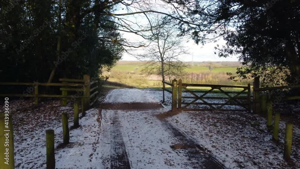 A farm track leading through a farm gate opens up to spectacular views of the Worcestershire Countryside, England, UK on a cold winters day. A farm track leading through a farm gate opens up to spectacular views of the Worcestershire Countryside, England, UK on a cold winters day.