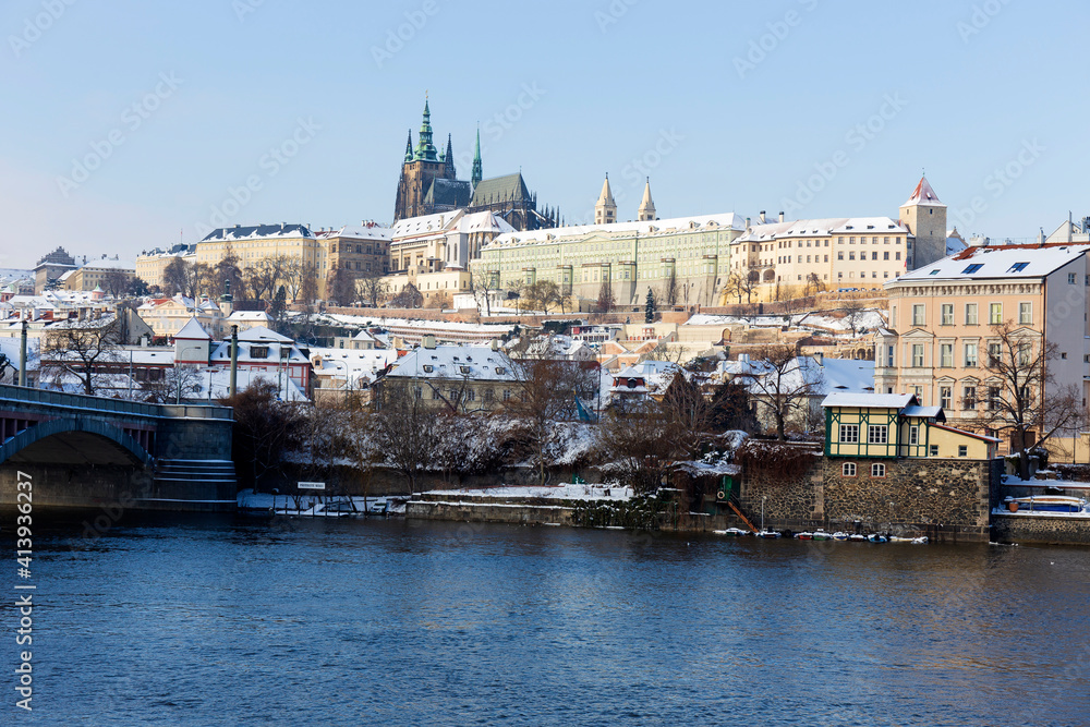 Snowy Prague Lesser Town with Prague Castle above River Vltava in the sunny Day , Czech republic