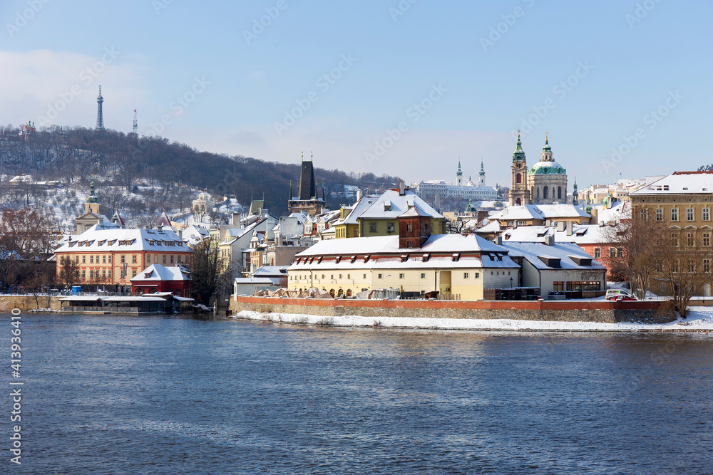 Snowy Prague Lesser Town with Prague Castle above River Vltava in the sunny Day , Czech republic