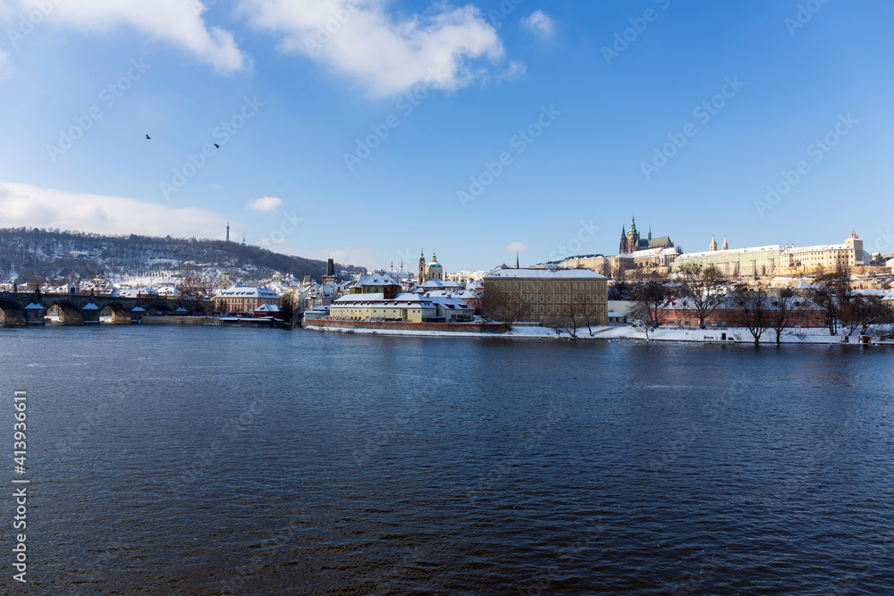 Obraz Snowy Prague Lesser Town with Prague Castle above River Vltava in the sunny Day , Czech republic