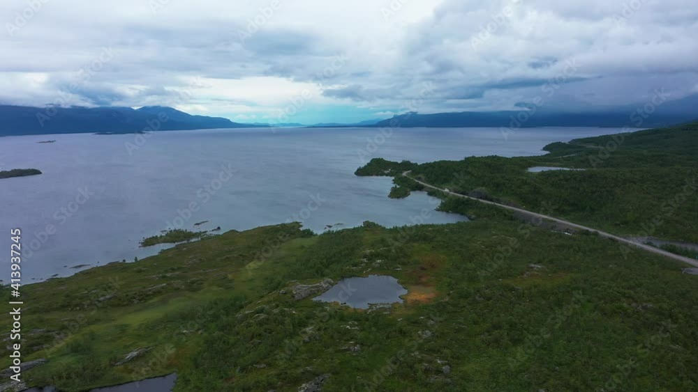 Aerial drone view of car on a polar road, at lake Tornetrask, in Norrbotten, Sweden Aerial drone view of car on a polar road, at lake Tornetrask, in Norrbotten, Sweden