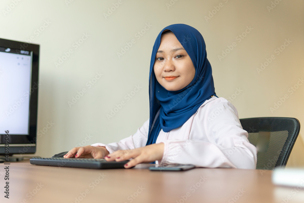Malay lady using laptop at home Malay lady using laptop at home