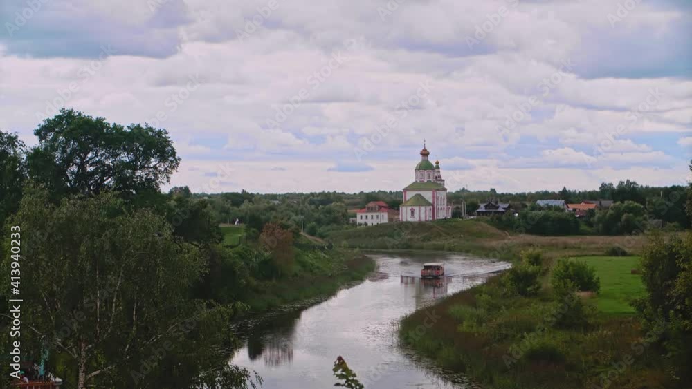 Suzdal, Russia. Attractions of the city of the museum. A ship sails along the river. Golden Ring of Russia Suzdal, Russia. Attractions of the city of the museum. A ship sails along the river. Golden Ring of Russia