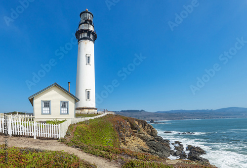 Pigeon Point lighthouse against the backdrop of a beautiful sky and ocean with waves, a great landscape of the Pacific coast in California