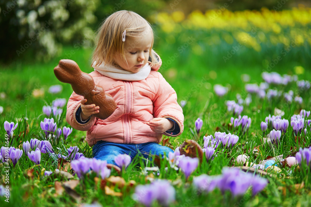 Cute little girl playing egg hunt on Easter Cute little girl playing egg hunt on Easter