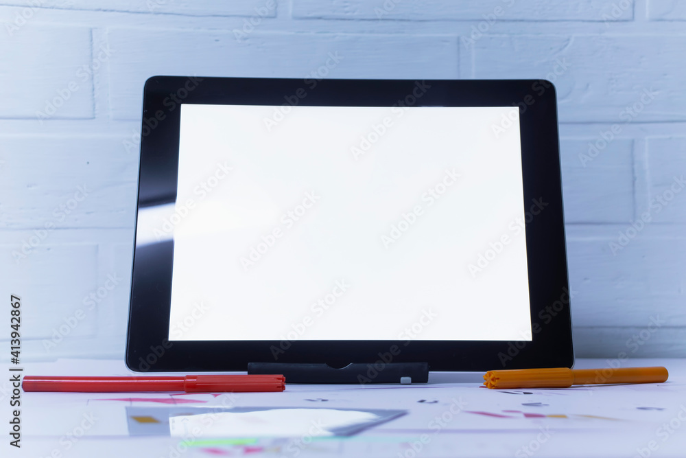 Creative workplace of a Graphic Designer with Tablet. Development of a logo for the company. Drawings and sketches on paper in a art studio office. Creative workplace of a Graphic Designer with Tablet. Development of a logo for the company. Drawings and sketches on paper in a art studio office.