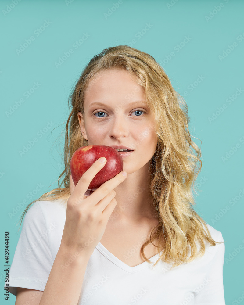 Portrait of young smiling woman with red apple. Fresh face, natural beauty, realistic. Clean young fresh skin without makeup and retouching. Healthy care Portrait of young smiling woman with red apple. Fresh face, natural beauty, realistic. Clean young fresh skin without makeup and retouching. Healthy care
