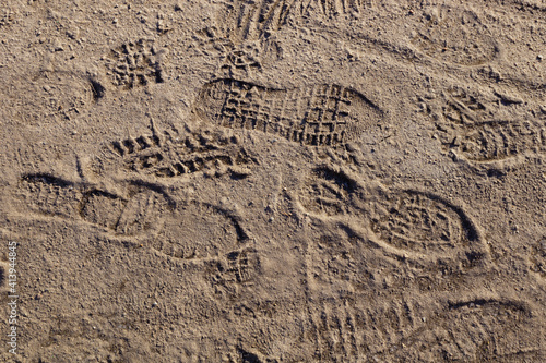chaotic footprints of man's shoes in the sand